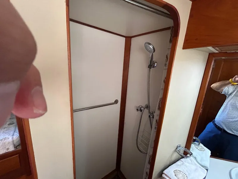 Slide: The Image of Shower area in 1986 Grand Banks 42 Classic yacht with wooden trim and handheld showerhead. - 42