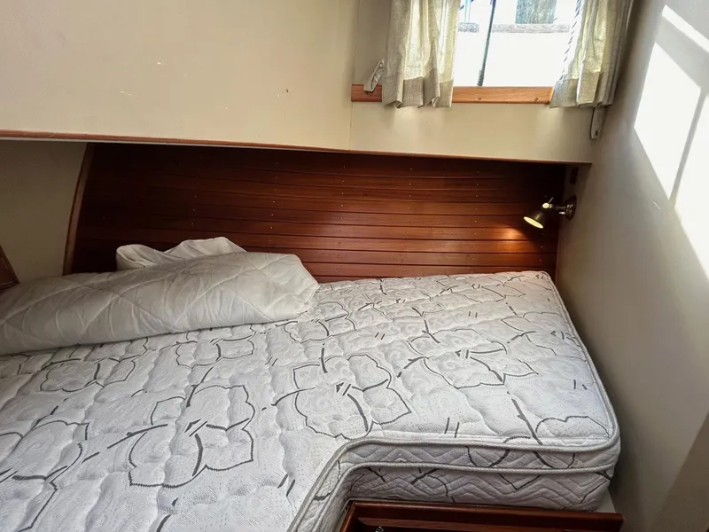 Slide: The Image of Cozy cabin bed in 1986 Grand Banks 42 Classic yacht with wooden paneling. - 45
