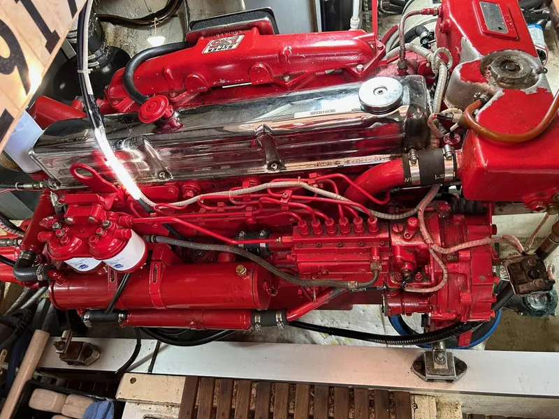 Slide: The Image of 1986 Grand Banks 42 Classic engine, vibrant red, detailed view. - 49