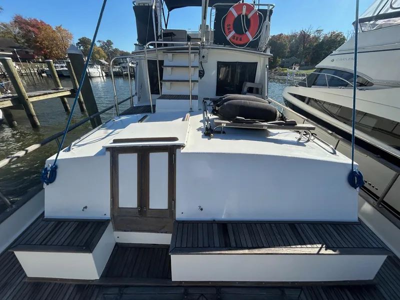 Slide: The Image of 1986 Grand Banks 42 Classic yacht docked, featuring spacious deck and classic design. - 6
