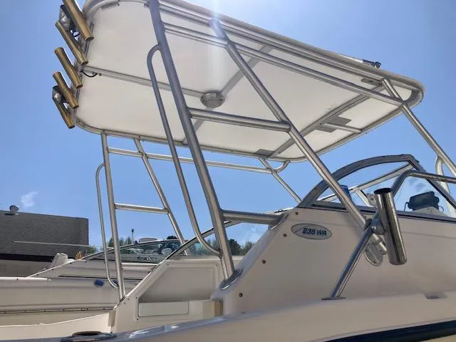 Slide: The Image of 2002 Sea Pro 235 Walk Around boat with T-top under clear blue sky. - 15