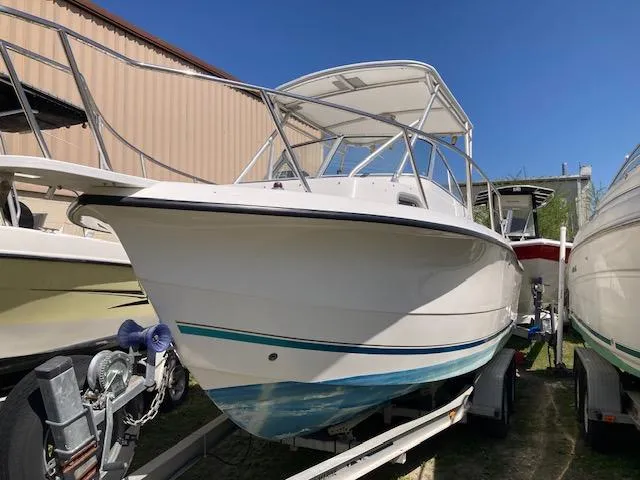 Slide: The Image of 2002 Sea Pro 235 Walk Around boat on trailer, parked outdoors. - 16