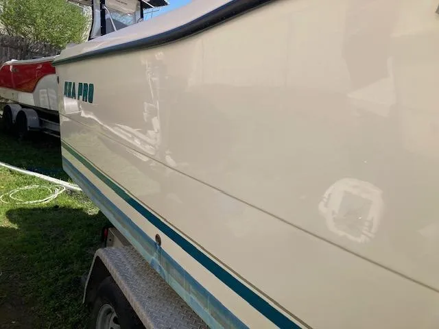 Slide: The Image of 2002 Sea Pro 235 Walk Around boat on trailer, side view. - 17