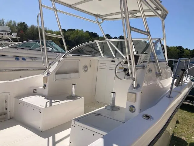 Slide: The Image of 2002 Sea Pro 235 Walk Around boat interior with seating and steering console. - 18
