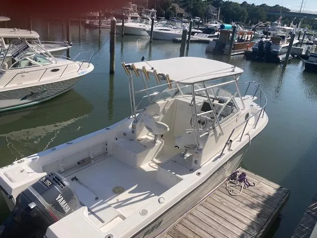 Slide: The Image of 2002 Sea Pro 235 Walk Around boat docked, featuring Yamaha outboard motor. - 19