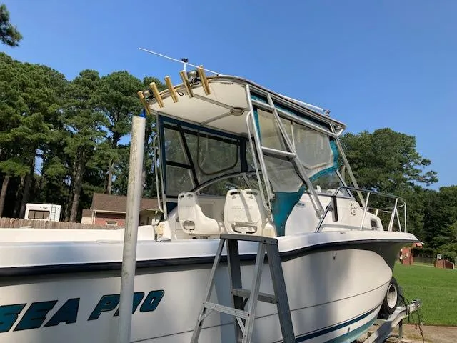 Slide: The Image of 2002 Sea Pro 235 Walk Around boat with ladder, parked outdoors. - 8