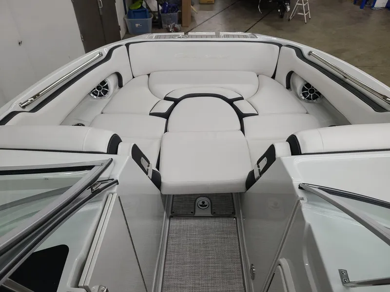 Slide: The Image of 2024 Crownline Eclipse E255 SURF boat interior with plush white seating. - 11