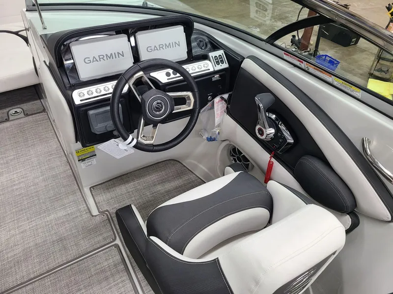 Slide: The Image of 2024 Crownline Eclipse E255 SURF boat cockpit with Garmin displays and modern steering wheel. - 7