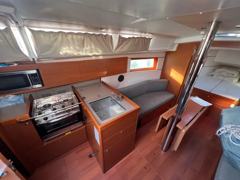 Slide: The Image of Interior of 2019 Beneteau Oceanis 35.1 yacht with kitchen and seating area. - 13