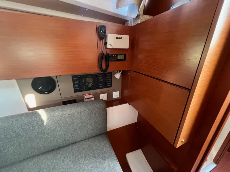 Slide: The Image of 2019 Beneteau Oceanis 35.1 interior with communication equipment and wooden cabinetry. - 15