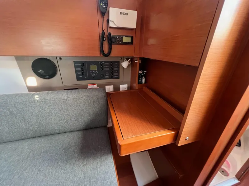 Slide: The Image of Interior of 2019 Beneteau Oceanis 35.1 yacht with navigation station and seating area. - 16