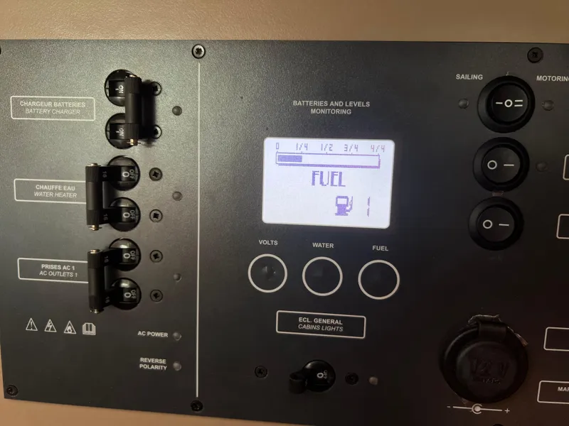 Slide: The Image of Control panel of 2019 Beneteau Oceanis 35.1 yacht, displaying fuel levels and switches. - 19