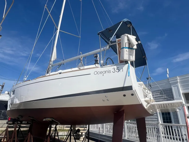 Slide: The Image of 2019 Beneteau Oceanis 35.1 sailboat on stands, clear sky background. - 2