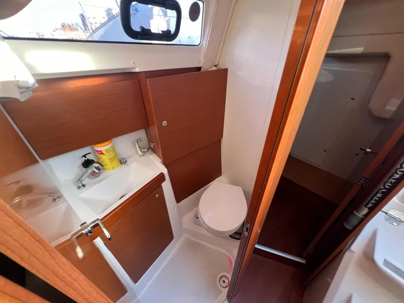 Slide: The Image of 2019 Beneteau Oceanis 35.1 bathroom with wooden cabinets and compact design. - 21