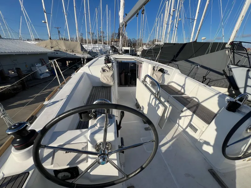 Slide: The Image of 2019 Beneteau Oceanis 35.1 sailboat cockpit with steering wheel and seating. - 7