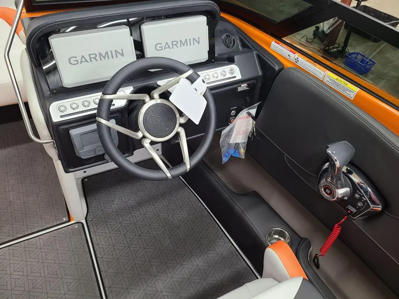 Slide: The Image of 2024 Crownline 240 SS LPX boat dashboard with Garmin displays and modern steering wheel. - 12