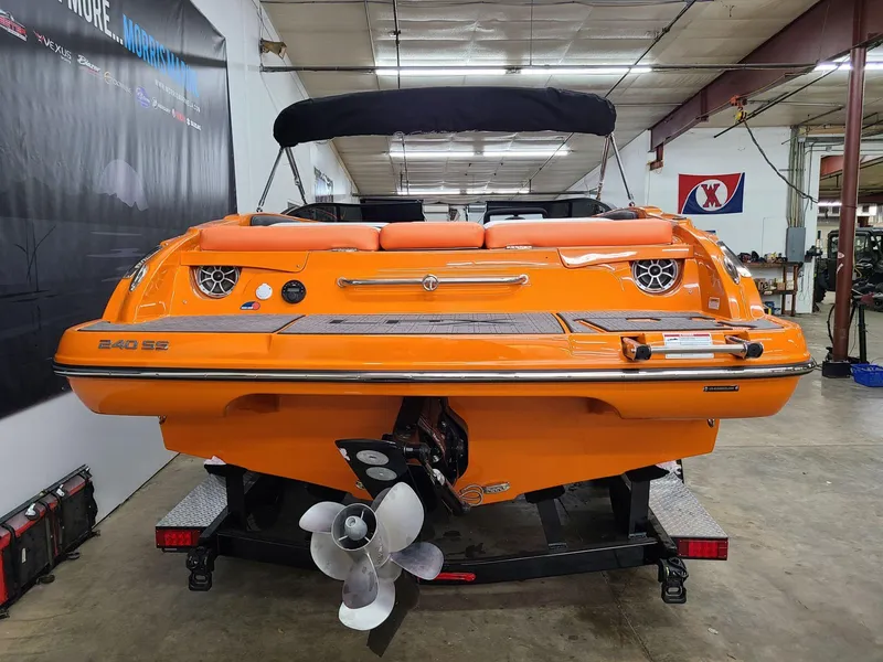 Slide: The Image of 2024 Crownline 240 SS LPX boat, vibrant orange, rear view in a showroom. - 3