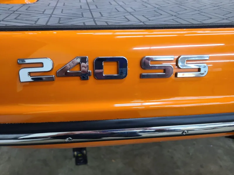 Slide: The Image of 2024 Crownline 240 SS LPX boat, orange exterior with chrome lettering. - 6