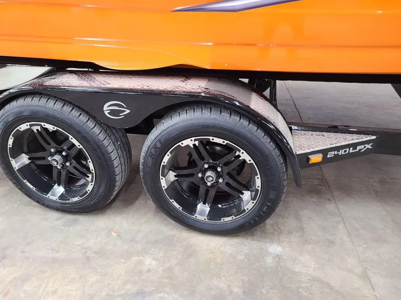 Slide: The Image of 2024 Crownline 240 SS LPX trailer with sleek black wheels and vibrant orange body. - 8