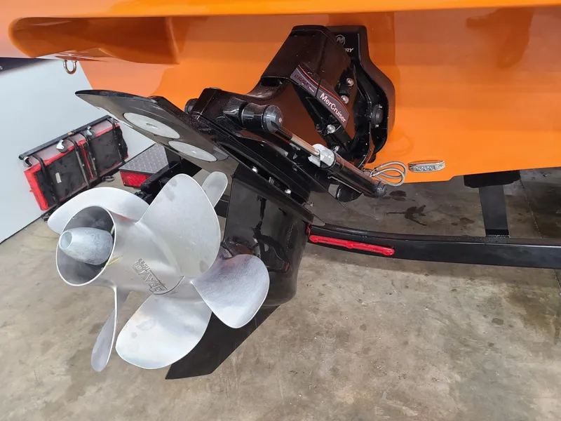 Slide: The Image of 2024 Crownline 240 SS LPX boat propeller and stern detail in a garage. - 9