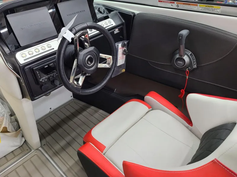 Slide: The Image of 2024 Crownline 240 SS SURF boat interior with steering wheel and control panel. - 12