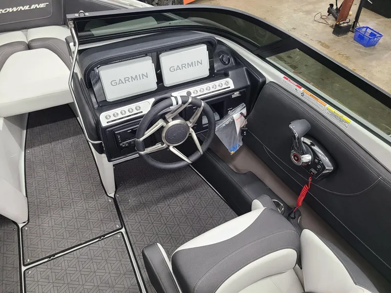 Slide: The Image of 2024 Crownline 220 SS LPX boat cockpit with dual Garmin displays and modern steering wheel. - 11