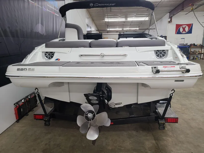 Slide: The Image of 2024 Crownline 220 SS LPX boat on trailer in a garage setting. - 3