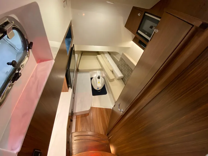 Slide: The Image of 2024 Pursuit S 358 cabin interior with wood finish and modern amenities. - 18