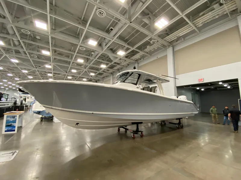 Slide: The Image of 2024 Pursuit S 358 boat displayed in an indoor showroom. - 3