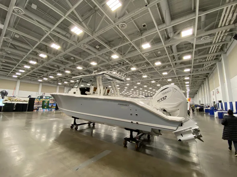 Slide: The Image of 2024 Pursuit S 358 boat displayed indoors at an exhibition hall. - 4