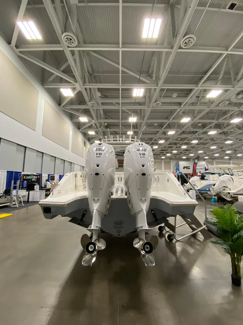 Slide: The Image of 2024 Pursuit S 358 boat with dual engines displayed indoors. - 5