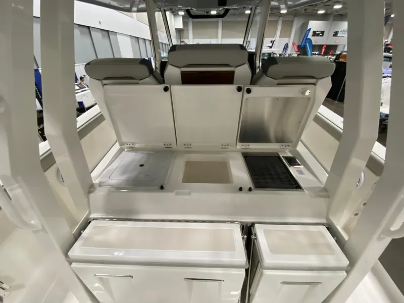 Slide: The Image of 2024 Pursuit S 358 boat interior with open storage compartments and seating. - 9