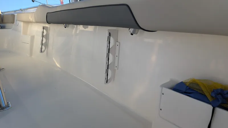 Slide: The Image of Interior view of 2025 Key West 239 FS boat, featuring sleek white design and storage compartments. - 10