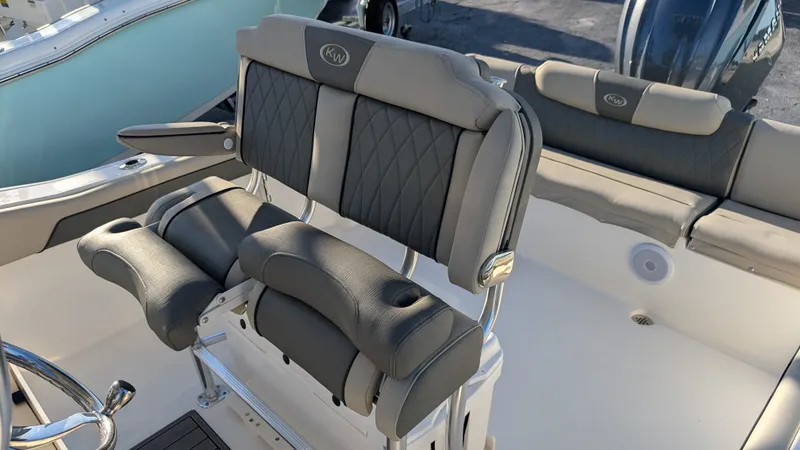 Slide: The Image of 2025 Key West 239 FS boat interior with cushioned seating and sleek design. - 13