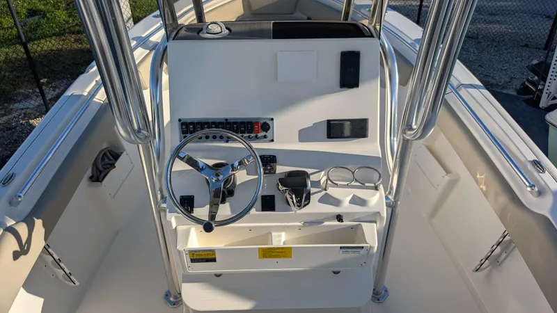 Slide: The Image of 2025 Key West 239 FS boat console with steering wheel and controls. - 14