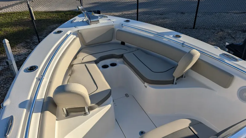 Slide: The Image of 2025 Key West 239 FS boat interior with cushioned seating and cup holders. - 16