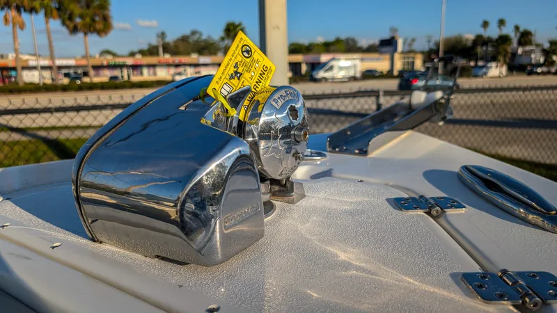 Slide: The Image of Close-up of a 2025 Key West 239 FS boat's anchor winch with a warning tag. - 19