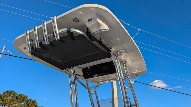 Slide: The Image of 2025 Key West 239 FS boat top view with rod holders against blue sky. - 20