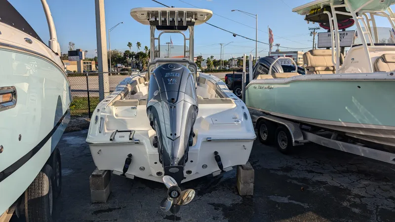 Slide: The Image of 2025 Key West 239 FS boat with outboard motor, parked on blocks. - 3