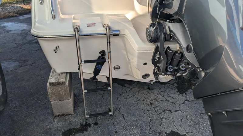 Slide: The Image of 2025 Key West 239 FS boat stern with ladder and engine detail. - 6