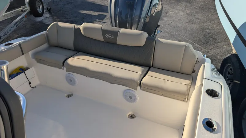 Slide: The Image of 2025 Key West 239 FS boat interior with cushioned seating and speakers. - 7