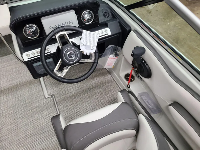 Slide: The Image of 2024 Crownline Eclipse E220 XS boat cockpit with Garmin navigation system. - 11