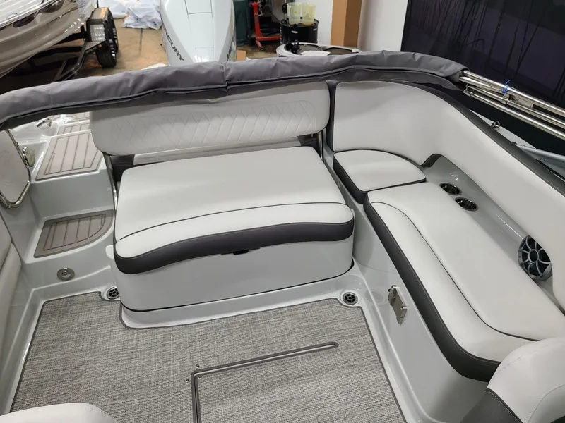 Slide: The Image of 2024 Crownline Eclipse E220 XS boat interior with sleek white and gray seating. - 13
