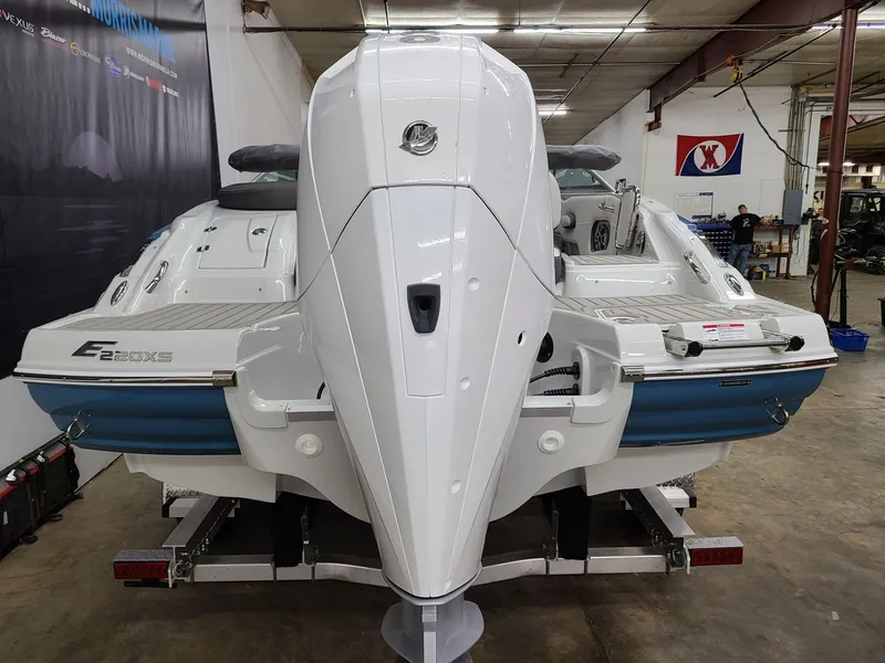 Slide: The Image of 2024 Crownline Eclipse E220 XS boat in a showroom, rear view. - 3