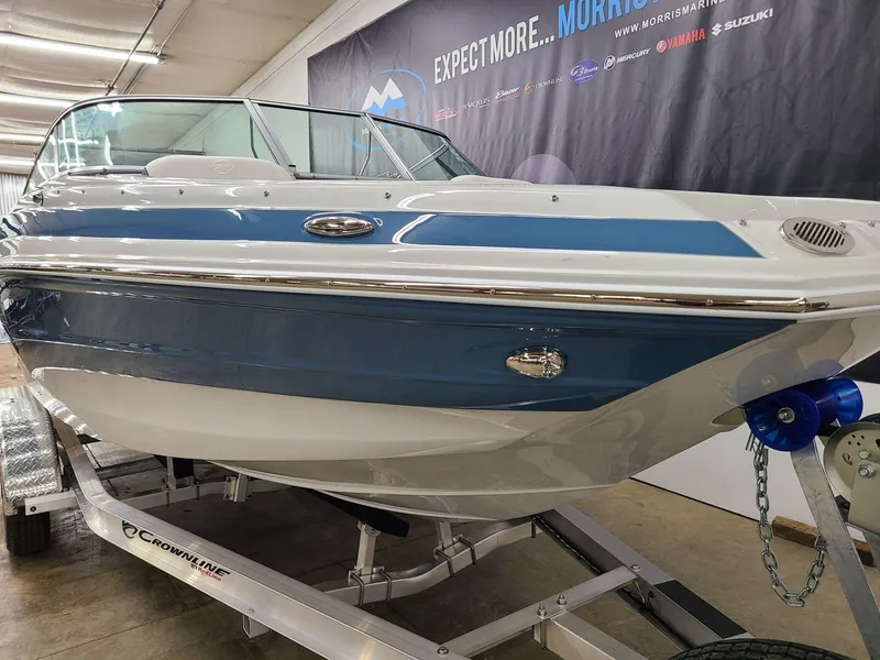 Slide: The Image of 2024 Crownline Eclipse E220 XS boat on display in showroom. - 4