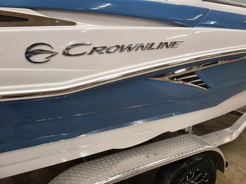 Slide: The Image of 2024 Crownline Eclipse E220 XS boat with blue and white exterior detailing. - 5