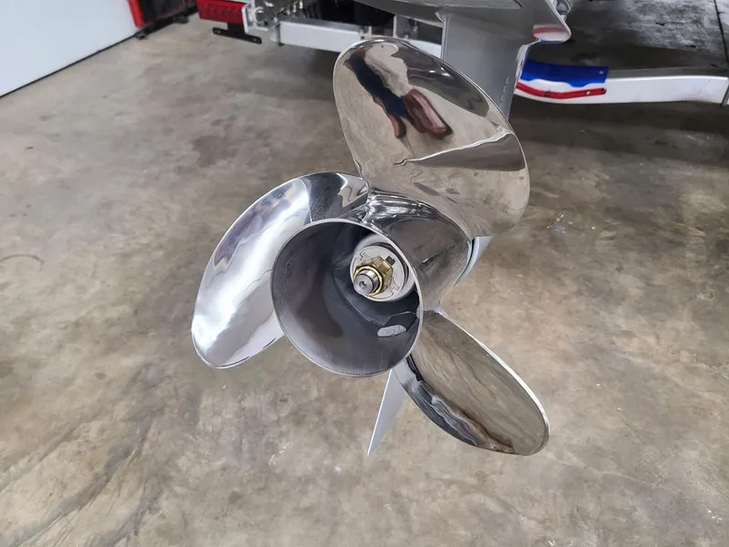 Slide: The Image of 2024 Crownline Eclipse E220 XS stainless steel boat propeller on concrete floor. - 6