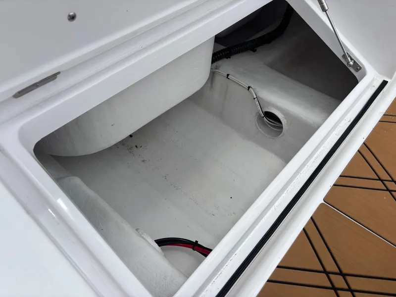 Slide: The Image of Open storage compartment in a 2024 Vtech 18 FLATS boat, featuring clean interior design. - 16