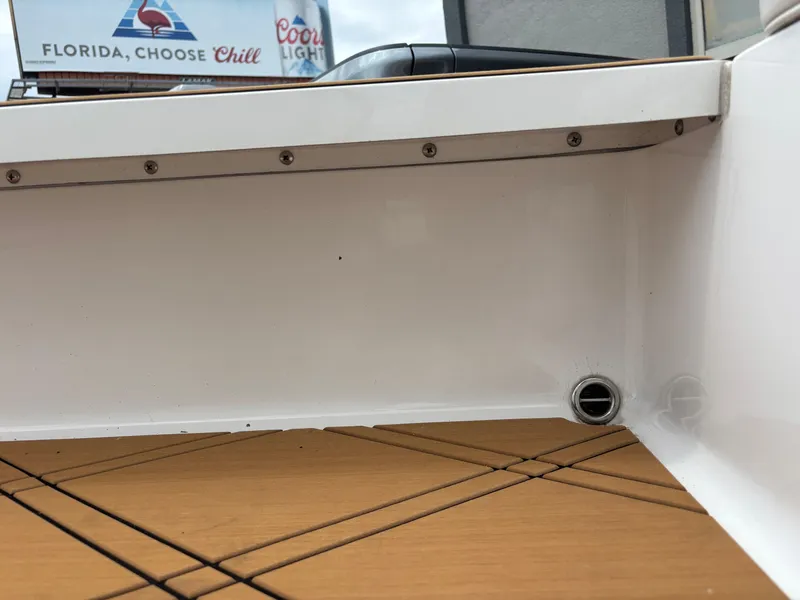 Slide: The Image of 2024 Vtech 18 FLATS boat interior with wooden flooring and white paneling. - 29