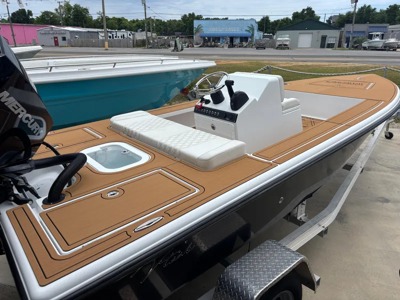 Slide: The Image of 2024 Vtech 18 FLATS boat with tan deck, white seating, and modern console. - 3